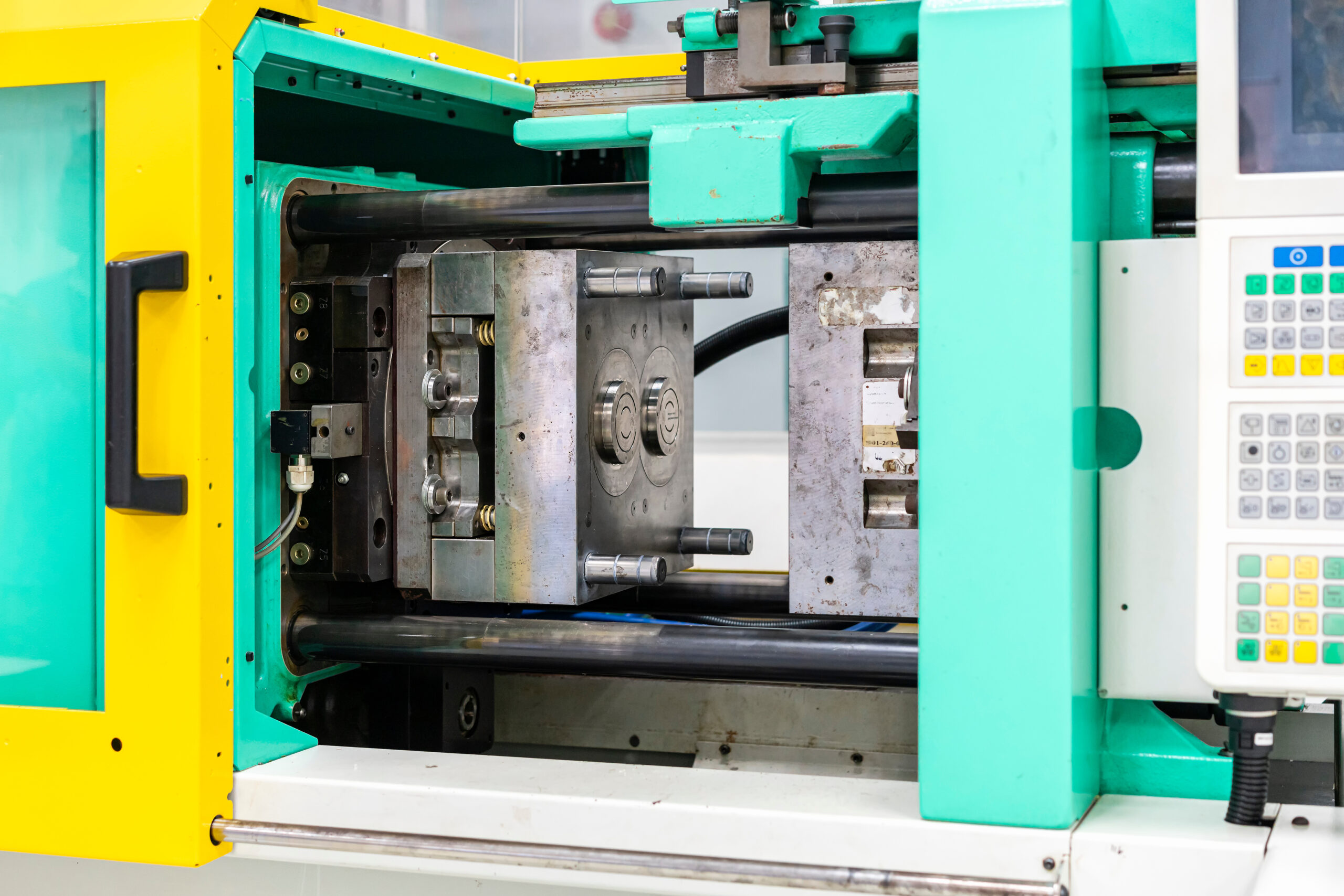 metal mould or plastic injection mold setup on high pressure injection molding machine for mass production or manufacturing in industrial